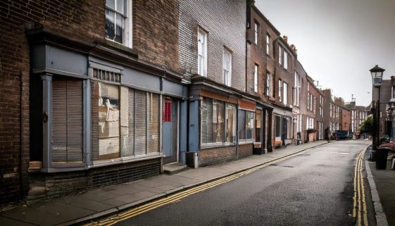 Firefly-grey-poor-british-high-street-with-boarded-up-shops-97323-scaled